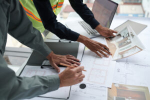 Architect and Foreman Discussing House Renovation,